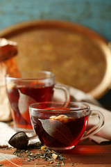 Beautiful vintage composition with herbal tea, on wooden table