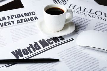 On-line news concept. Computer mouse, cup of coffee and