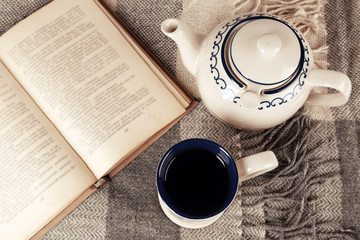 Cup of tea with book on table close-up