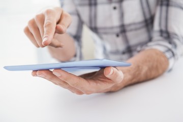 Casual businessman using tablet at desk