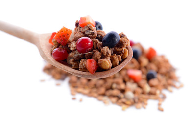 Granola in spoon isolated on white