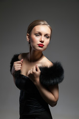 Young and beautiful woman in retro style with fur