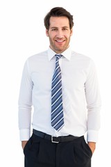 Smiling businessman standing with hands in pockets
