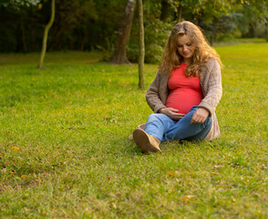 Fototapeta premium Beautiful pregnant blonde in nature
