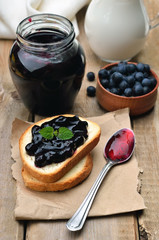 Blueberry jam on toast bread on wooden table