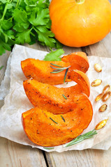 Baked pumpkin slices on rustic table