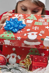 The girl looks in the sack of Santa Claus