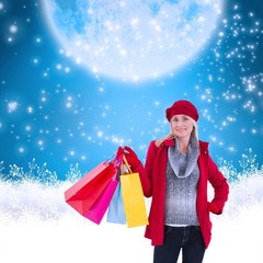 Blonde in winter clothes holding shopping bags
