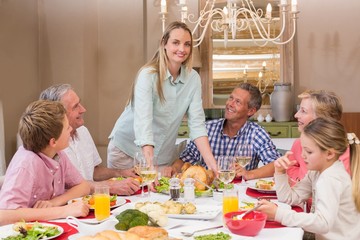 Woman serving christmas dinner to her family
