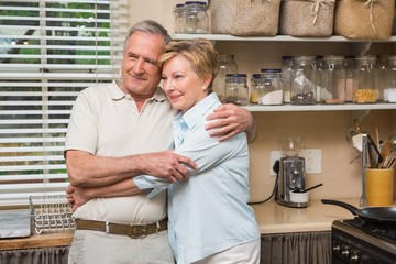 Fototapeta na wymiar Senior couple hugging and smiling