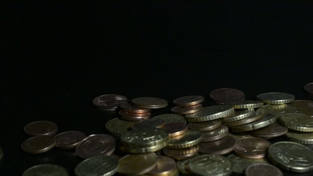Hand lets coins fall