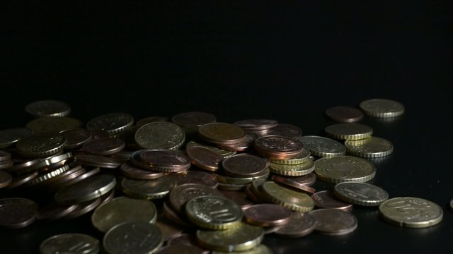 Hands let coins fall