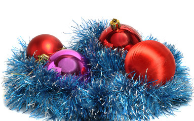 red Christmas balls on a bed of artificial rain