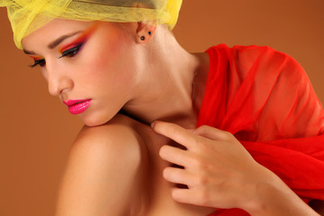 Beautiful young woman in the studio, wearing colorful make up
