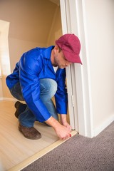 Handyman laying down a carpet