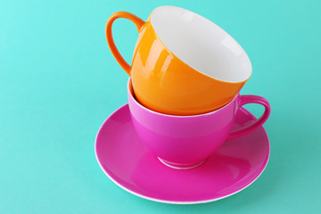 Colorful cups on color background
