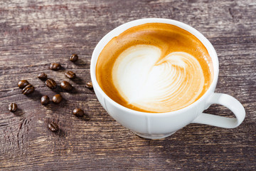 Cup of coffee on old wooden table