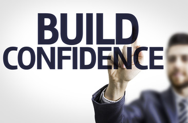 Business man pointing the text: Build Confidence