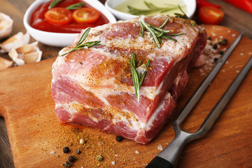 Raw meat on wooden table, close-up
