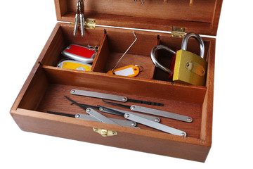 Set of keys and lock picks in wooden box isolated on white