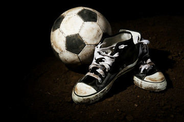 Soccer ball on ground on dark background