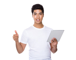 Fototapeta na wymiar Man use of tablet and thumb up