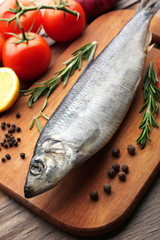 Fresh raw fish and food ingredients on table