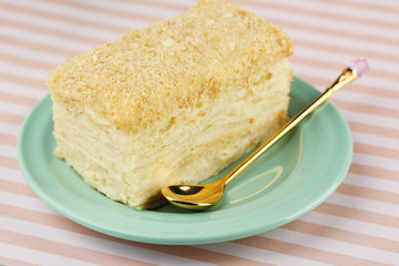 Napoleon cake on plate on table close-up