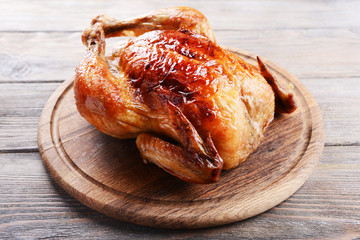 Delicious baked chicken on table close-up