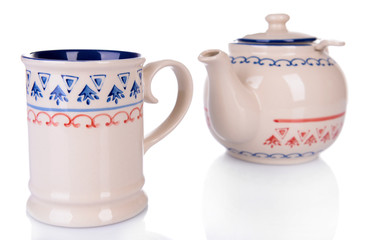 Cup of tea with teapot isolated on white