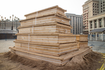 wooden piles on a pallet, used at the construction site