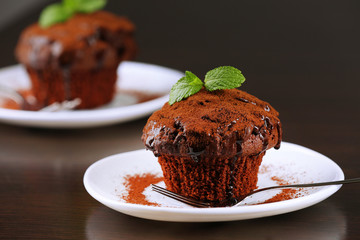 Yummy chocolate cupcake on table