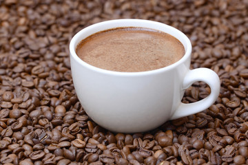 cup of coffee on a coffee beans background