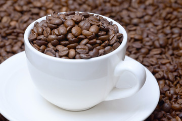 cup with coffee grains on a saucer