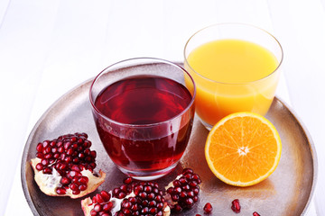 Glasses of fresh orange and pomegranate juice