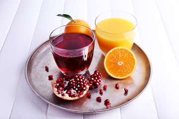 Glasses of fresh orange and pomegranate juice