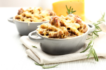 Pasta baked with vegetables and cheese in ceramic pot