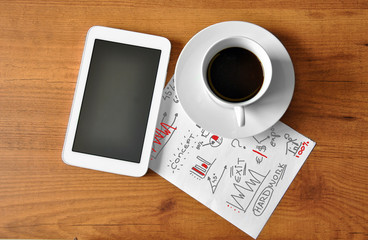 coffee with digital tablet and analytical paper