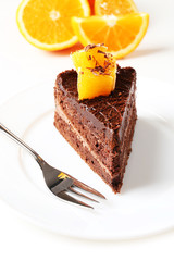Yummy chocolate cake with orange, close-up