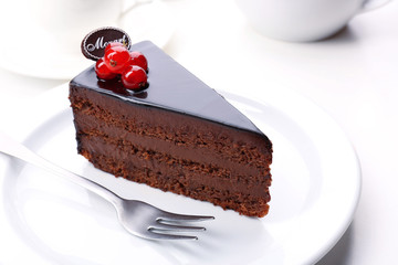 Delicious chocolate cake on plate on table on light background