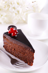 Delicious chocolate cake on plate on table on light background