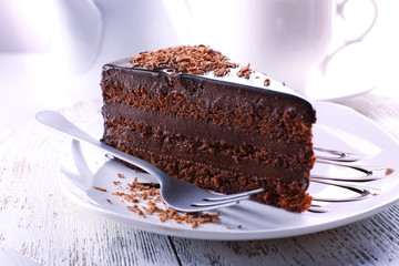 Delicious chocolate cake on plate on table on light background