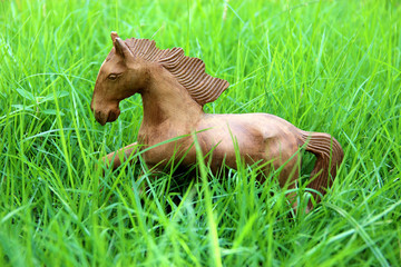 Fototapeta premium Wood horse on grass field