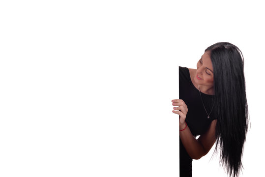 Young Woman Peeking Behind Empty White Billboard