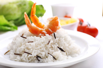 Boiled rice with shrimps served on table, close-up