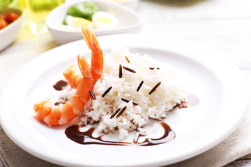 Boiled rice with shrimps served on table, close-up