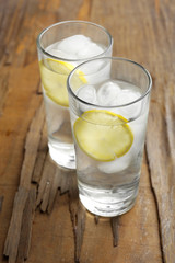 Glasses with ice cubes on wooden table