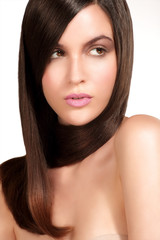 Obraz premium Beauty model showing perfect skin and long healthy brown hair