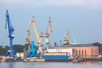 Fototapeta premium port cranes with old warehose. Port of St.Petersburg, Russia