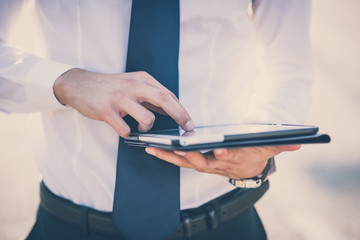 close up businessman man hand using tablet device